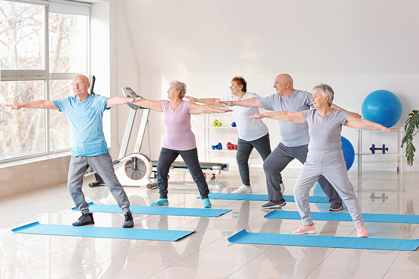 Elderly people exercising in gym 