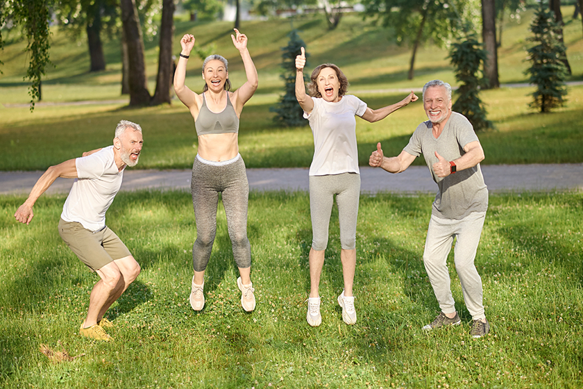 Group of healthy runners team jumping in the air
